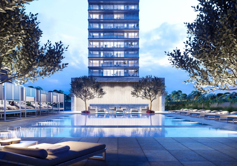 Evening pool at 2000 Ocean Hallandale Beach with cabanas, loungers and illuminated tower backdrop, showcasing luxury and ultra luxury resale condos amenities in South Florida.