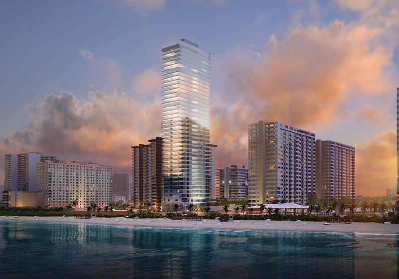 2000 Ocean Hallandale Beach oceanfront tower at sunset reflected on the Atlantic, showcasing luxury and ultra luxury resale condos on South Florida's coastline.