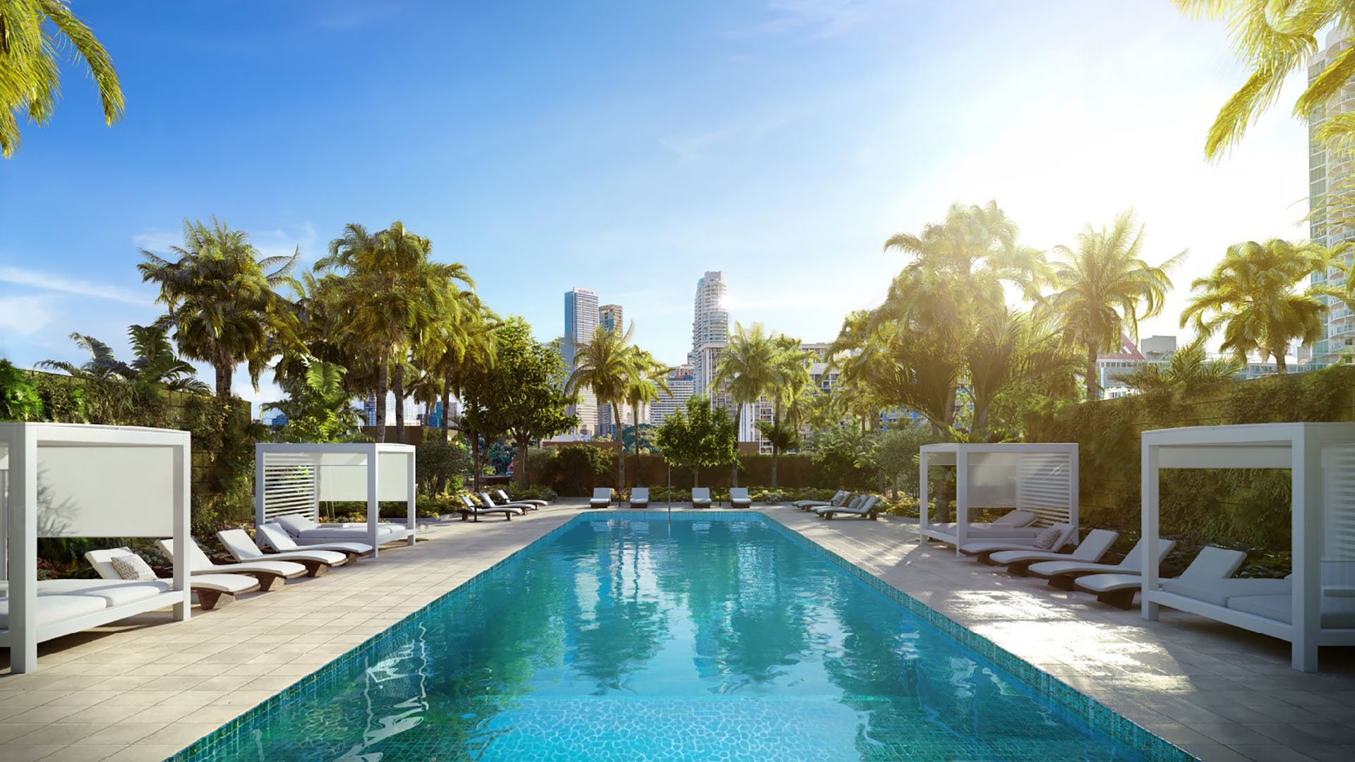 2200 Brickell resort-style pool with cabanas, loungers and palm landscaping, city skyline view, showcasing luxury and ultra luxury preconstruction condos amenities in Brickell, Miami, Florida.