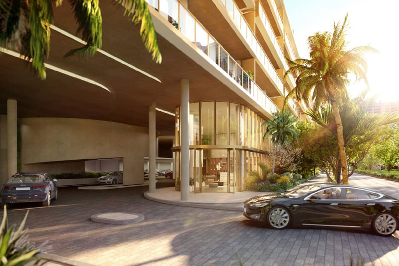 2200 Brickell arrival porte-cochere and glass lobby at sunset with palm-lined drive, showcasing luxury and ultra luxury preconstruction condos in Brickell, Miami, Florida.