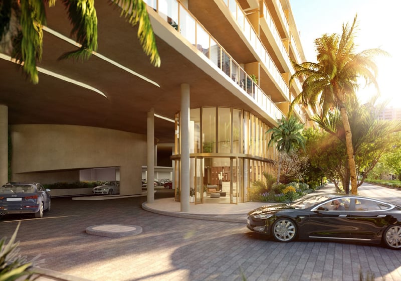 2200 Brickell arrival porte-cochere and glass lobby at sunset with palm-lined drive, showcasing luxury and ultra luxury preconstruction condos in Brickell, Miami, Florida.
