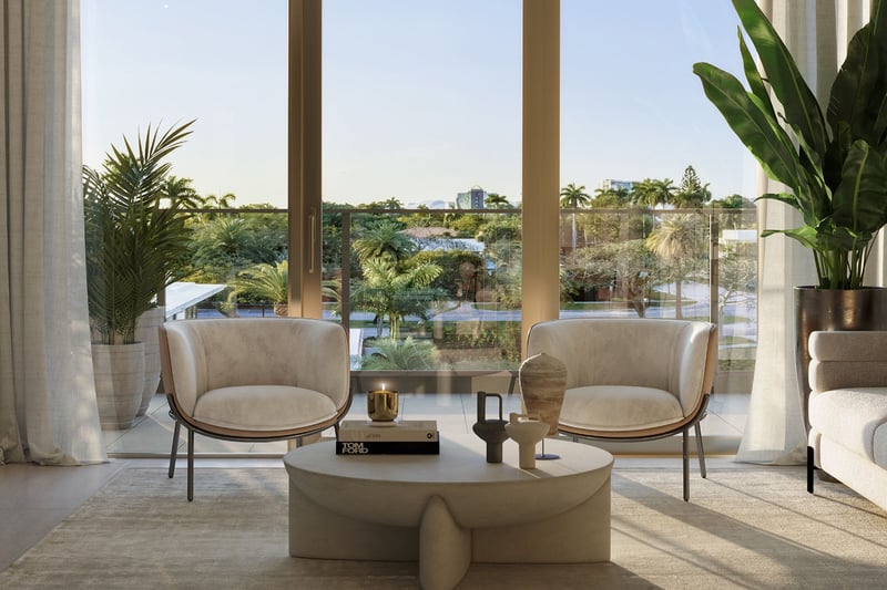 2200 Brickell in Brickell, Miami, Florida living room seating by sliding glass doors and balcony, overlooking lush tropical gardens, promoting luxury and ultra luxury preconstruction condos with indoor-outdoor lifestyle.
