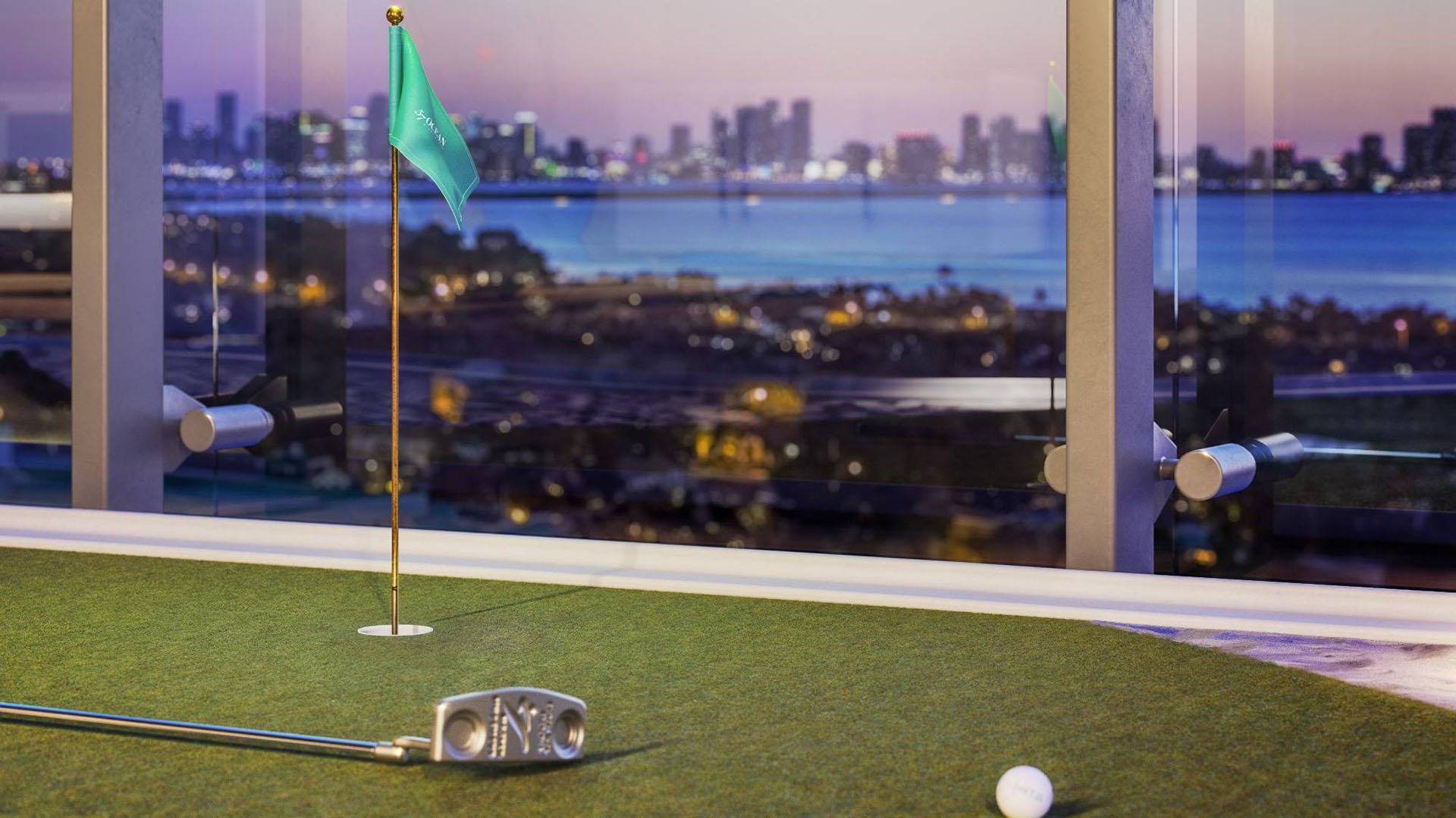 57 Ocean Miami Beach indoor golf simulator with cityscape view, showcasing luxury and ultra luxury preconstruction condos entertainment amenities in Mid-Beach, Miami Beach, Florida.