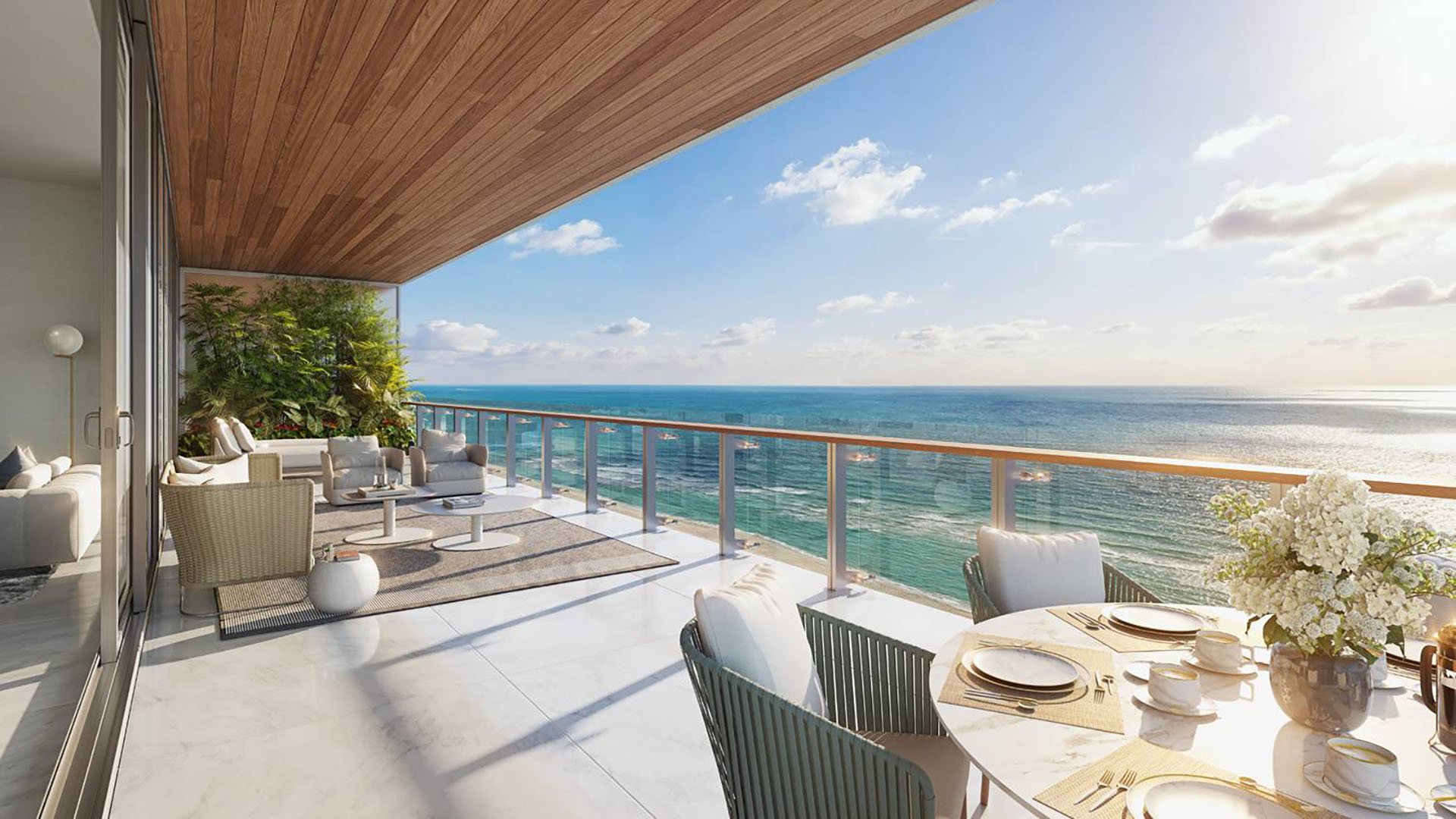 57 Ocean Miami Beach ocean-view balcony setup with seating and table, showcasing luxury and ultra luxury preconstruction condos in Mid-Beach on Millionaire's Row, Miami Beach, Florida.
