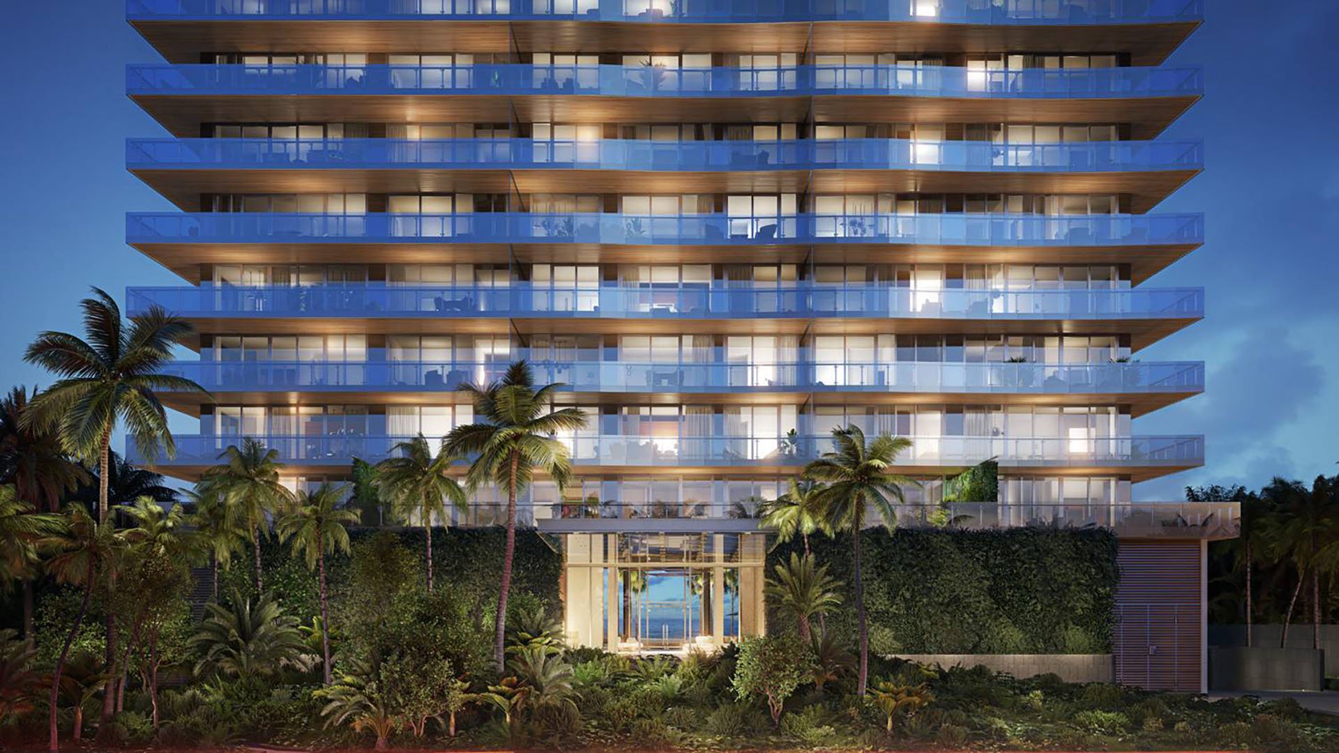 57 Ocean Miami Beach modern apartment building at night with illuminated facade, showcasing luxury and ultra luxury preconstruction condos in Mid-Beach on Millionaire's Row, Miami Beach, Florida.