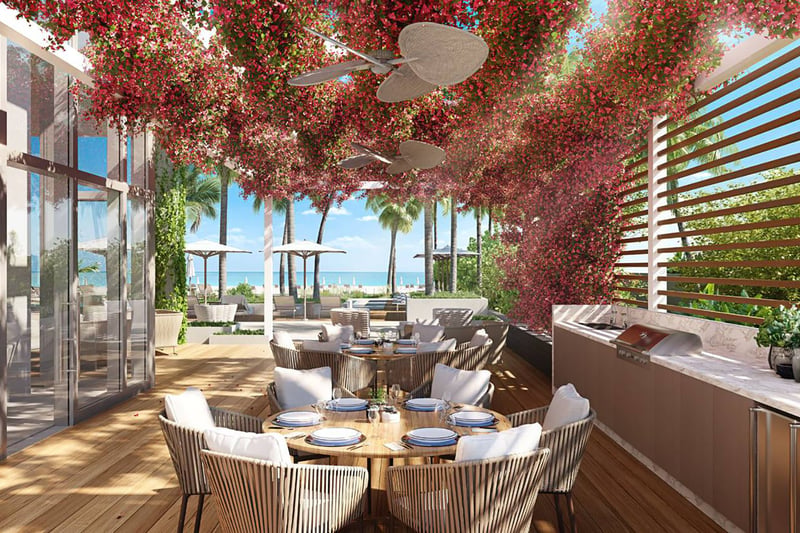 57 Ocean Miami Beach outdoor dining area with waterfront view, showcasing luxury and ultra luxury preconstruction condos lifestyle on Millionaire's Row, Mid-Beach, Miami Beach, Florida.