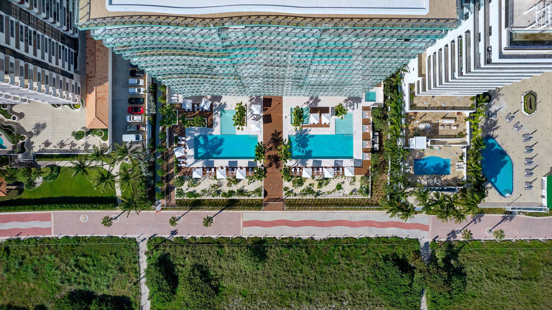57 Ocean Miami Beach aerial view of resort pool complex by the ocean, showcasing luxury and ultra luxury preconstruction condos amenities on Millionaire's Row, Mid-Beach, Miami Beach, Florida.