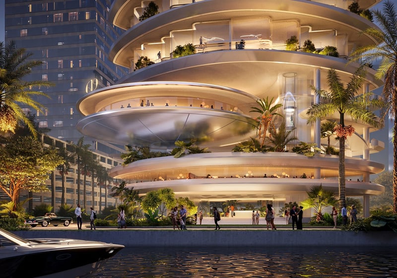 619 Residences by Foster + Partners + Nobu Hospitality in 619 Brickell, Miami, Florida, showcasing luxury and ultra luxury preconstruction condos with a dramatic waterfront entrance, illuminated curved terraces, tropical landscaping and private boat arrival at night.