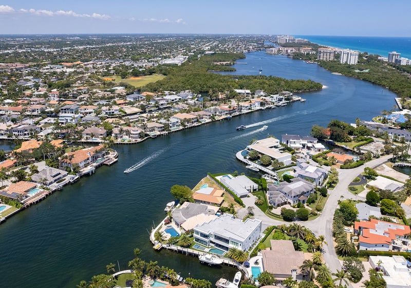 749 Bamboo Dr Boca Raton aerial waterway view of coastal homes and docks, showcasing luxury and ultra luxury resale waterfront living near Boca Raton condos in Sun and Surf, Florida.