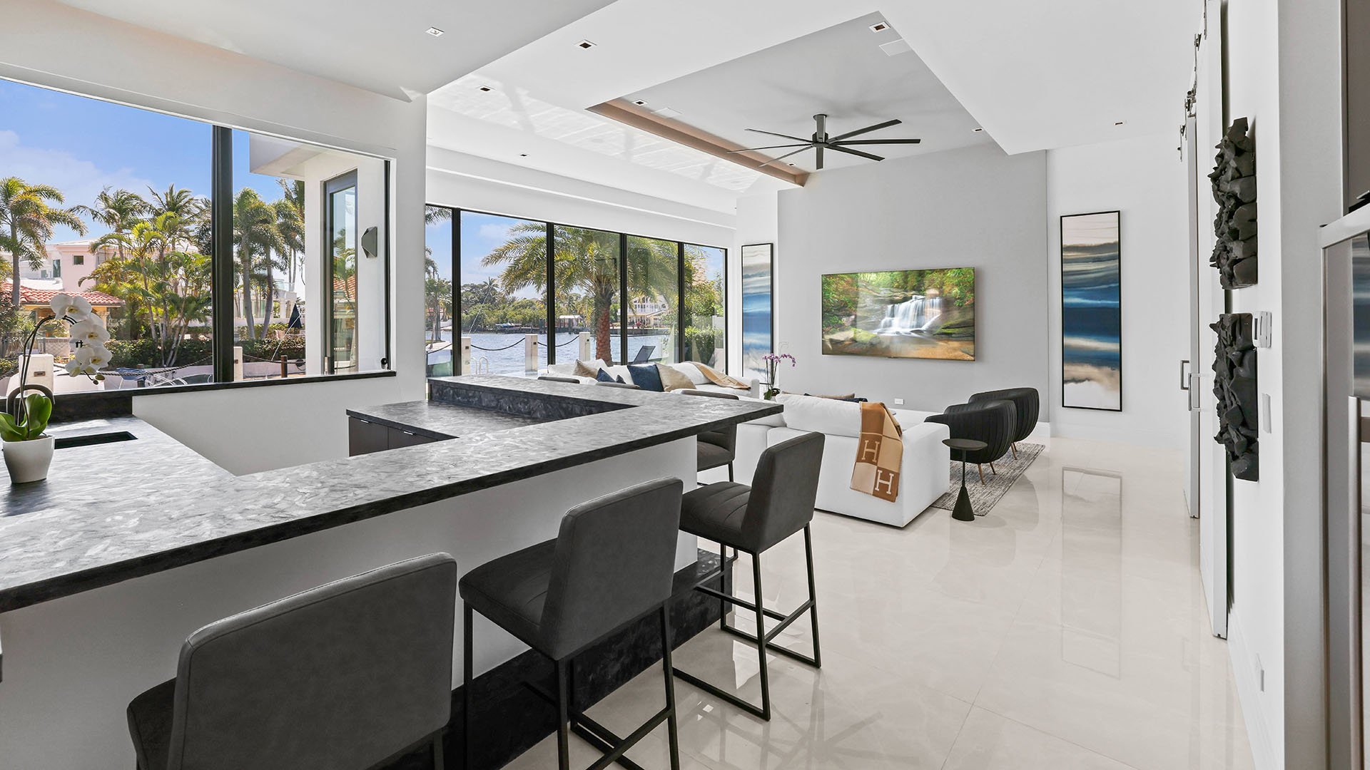 749 Bamboo Dr Boca Raton open kitchen and living room with waterfront view, showcasing luxury and ultra luxury resale Sun and Surf interiors beyond condos, Boca Raton, Florida.