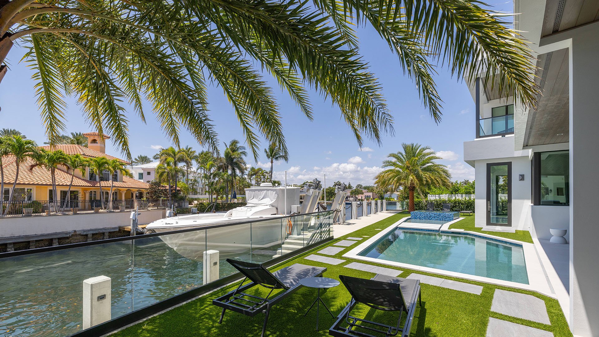 749 Bamboo Dr Boca Raton modern waterfront home with pool view and glass facade, showcasing luxury and ultra luxury resale Sun and Surf living beyond condos, Boca Raton, Florida.