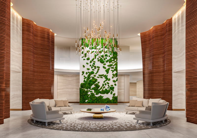 Alina Residences Boca Raton lobby with green wall art; luxury arrival for ultra luxury resale condos in Boca Raton, FL. Featuring modern design.