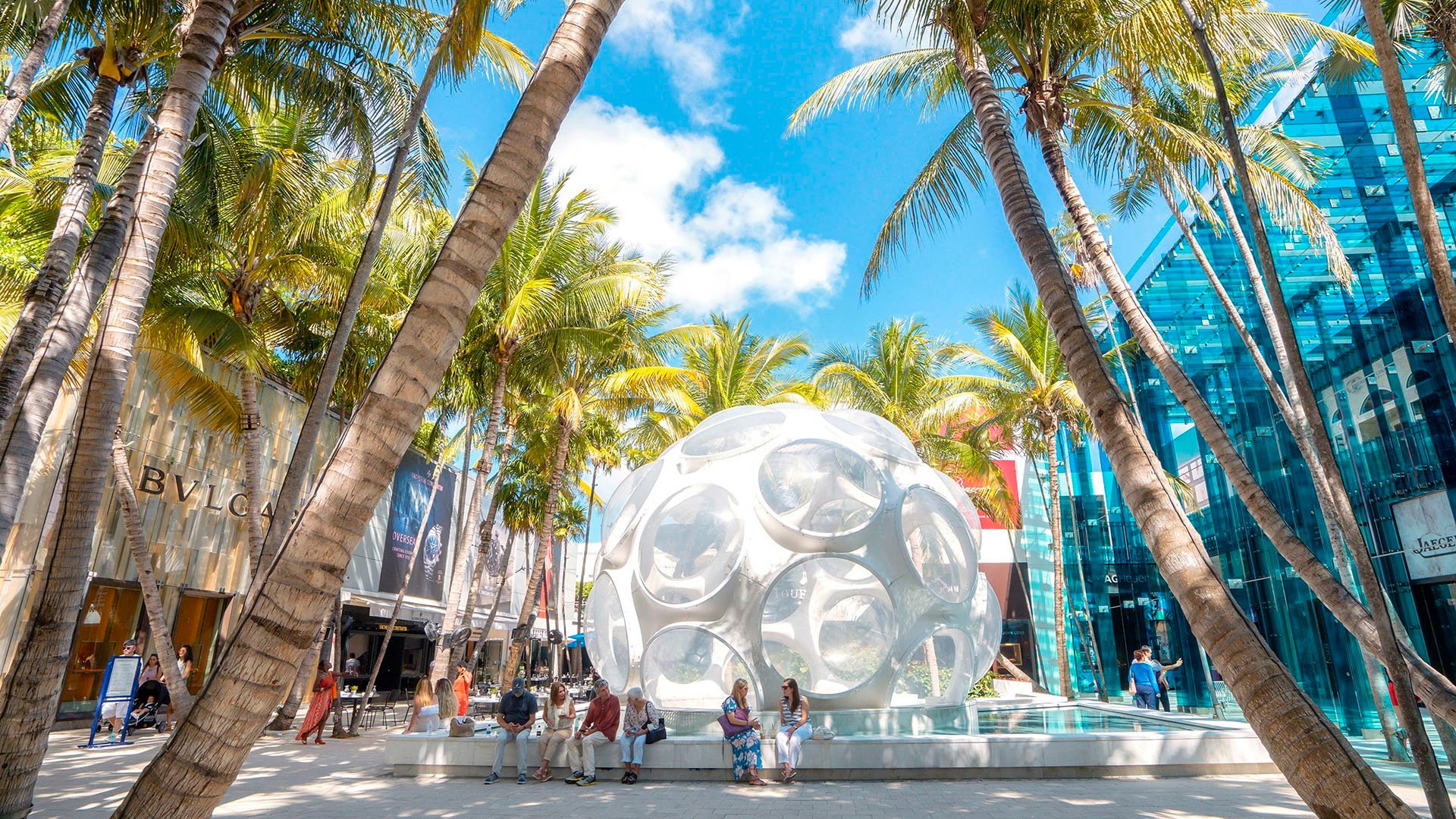 Bal Harbour Shops near Alma Bay Harbor in Bay Harbor Islands, Miami, highlighting the lifestyle of luxury and ultra luxury preconstruction condos with palm-lined retail and outdoor sculpture.