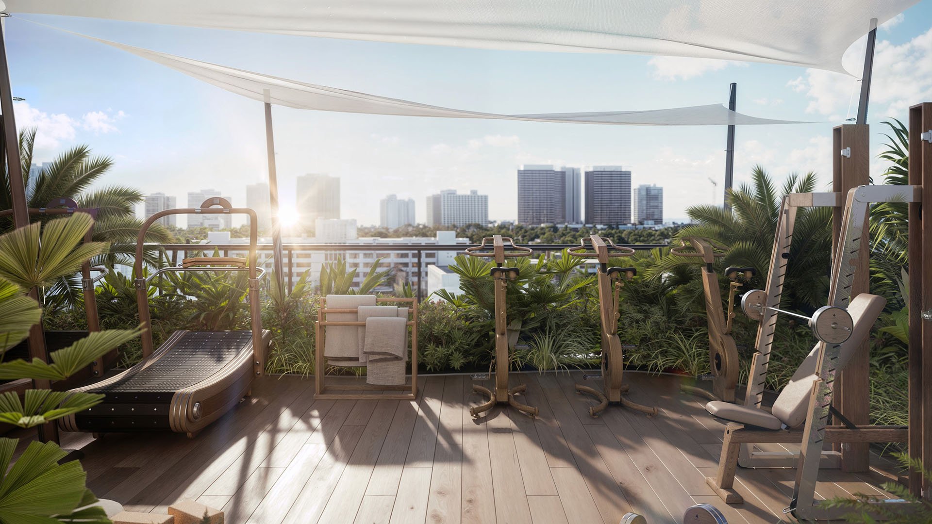 Rooftop fitness garden at Alma Bay Harbor in Bay Harbor Islands, Miami, highlighting amenities for luxury and ultra luxury preconstruction condos with cardio equipment, greenery and skyline views.