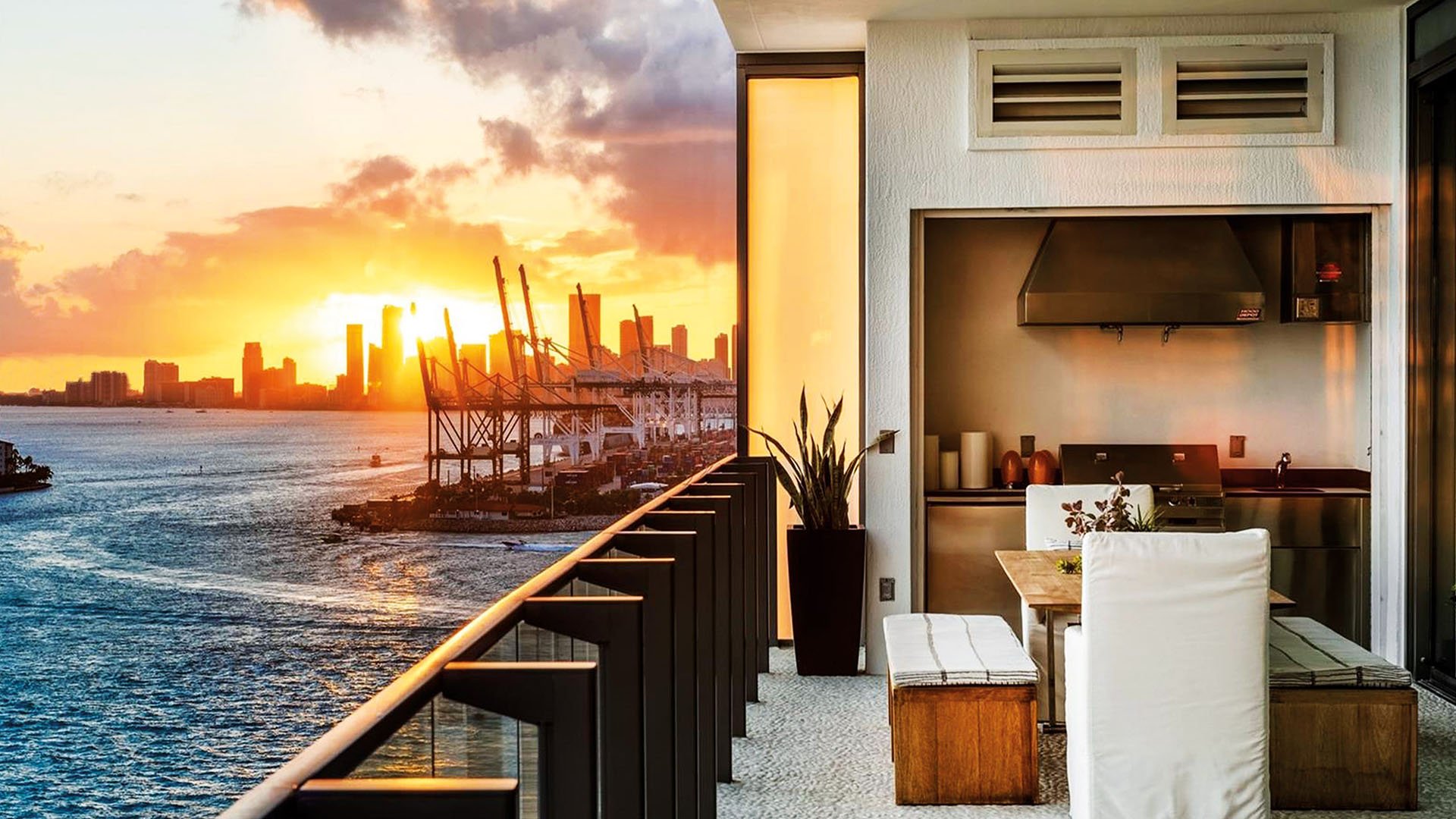 Sunset terrace with an outdoor kitchen, dining nook and skyline views at Apogee in South Beach, reflecting luxury and ultra luxury condos with dramatic waterfront sunsets.