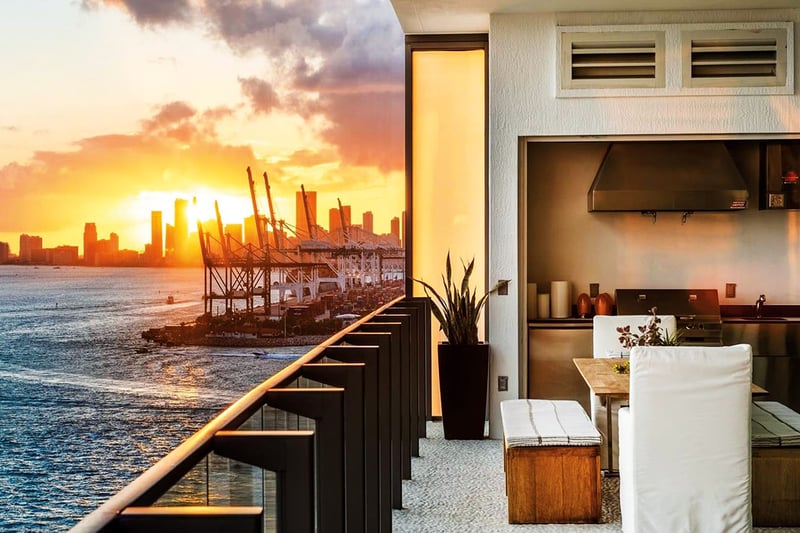 Sunset terrace with an outdoor kitchen, dining nook and skyline views at Apogee in South Beach, reflecting luxury and ultra luxury condos with dramatic waterfront sunsets.