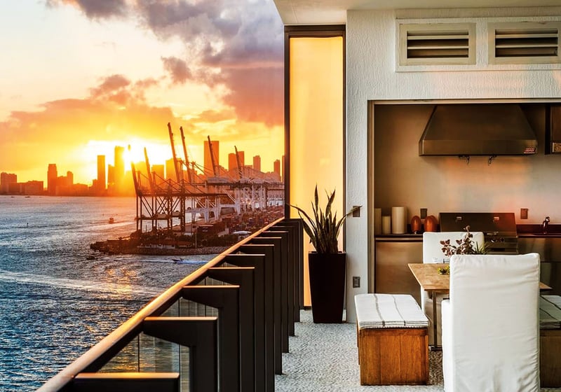 Sunset terrace with an outdoor kitchen, dining nook and skyline views at Apogee in South Beach, reflecting luxury and ultra luxury condos with dramatic waterfront sunsets.