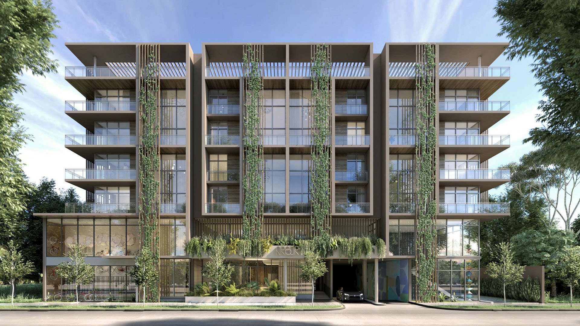 Front exterior of Arbor in Coconut Grove with balconies, vertical gardens and a lush landscaped facade, representing luxury and ultra luxury condos in a boutique mid-rise setting.