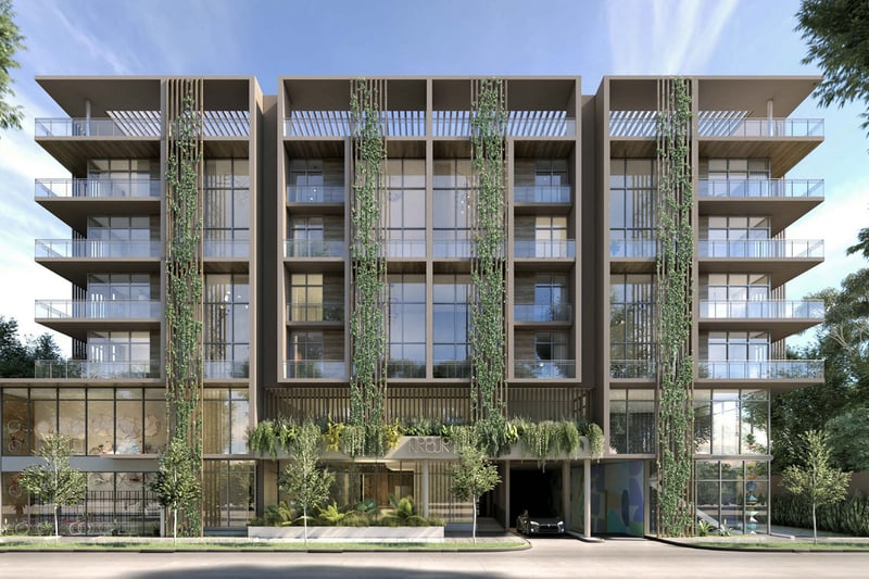 Front exterior of Arbor in Coconut Grove with balconies, vertical gardens and a lush landscaped facade, representing luxury and ultra luxury condos in a boutique mid-rise setting.