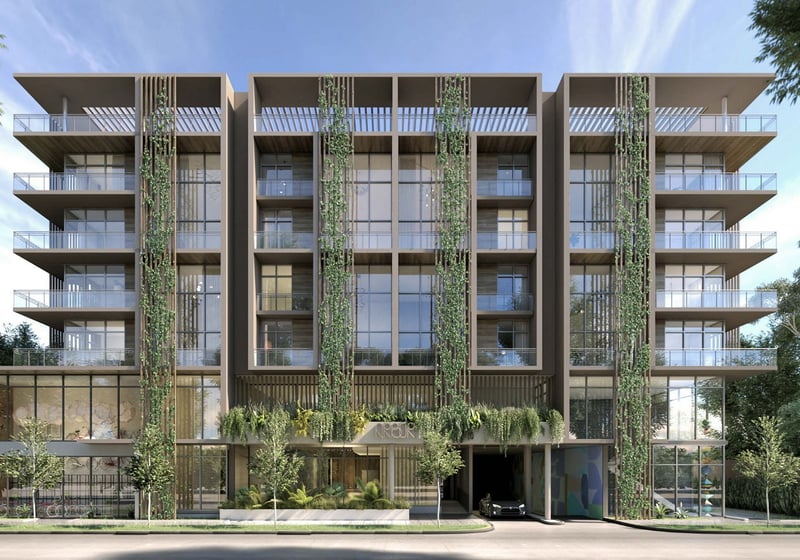Front exterior of Arbor in Coconut Grove with balconies, vertical gardens and a lush landscaped facade, representing luxury and ultra luxury condos in a boutique mid-rise setting.