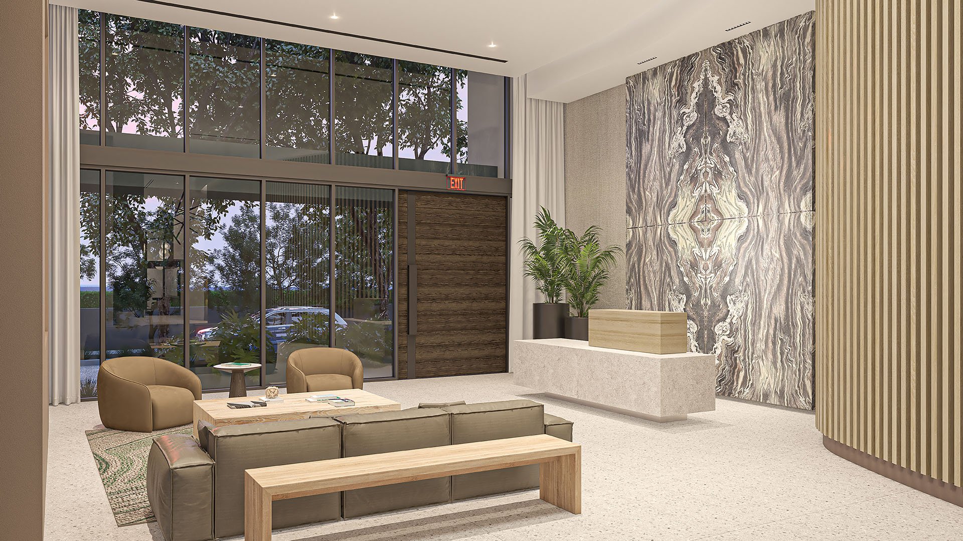 Evening lobby view with a reception desk, stone feature wall and tall window wall at Arbor in Coconut Grove, presenting luxury and ultra luxury condos with a polished boutique entrance.