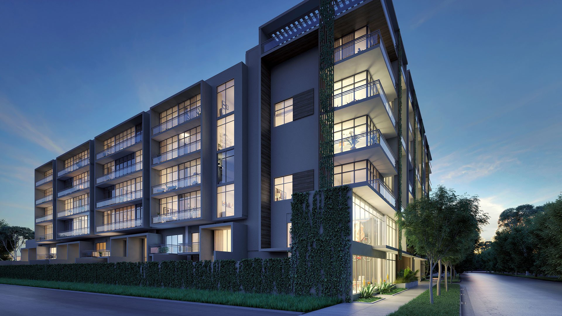 Dusk corner exterior of Arbor in Coconut Grove with stacked balconies, expansive glass and illuminated interiors, capturing luxury and ultra luxury condos in a low-rise modern building.