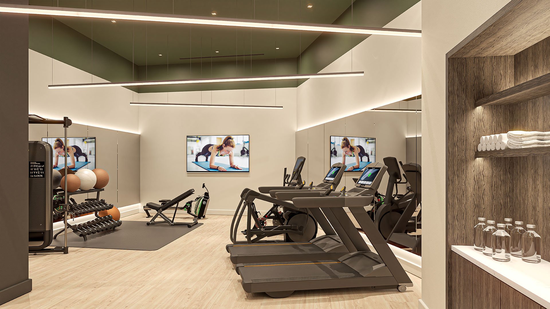 Fitness center with treadmills, strength equipment, mirrored walls and integrated towel storage at Arbor in Coconut Grove, highlighting luxury and ultra luxury condos with a polished wellness amenity.