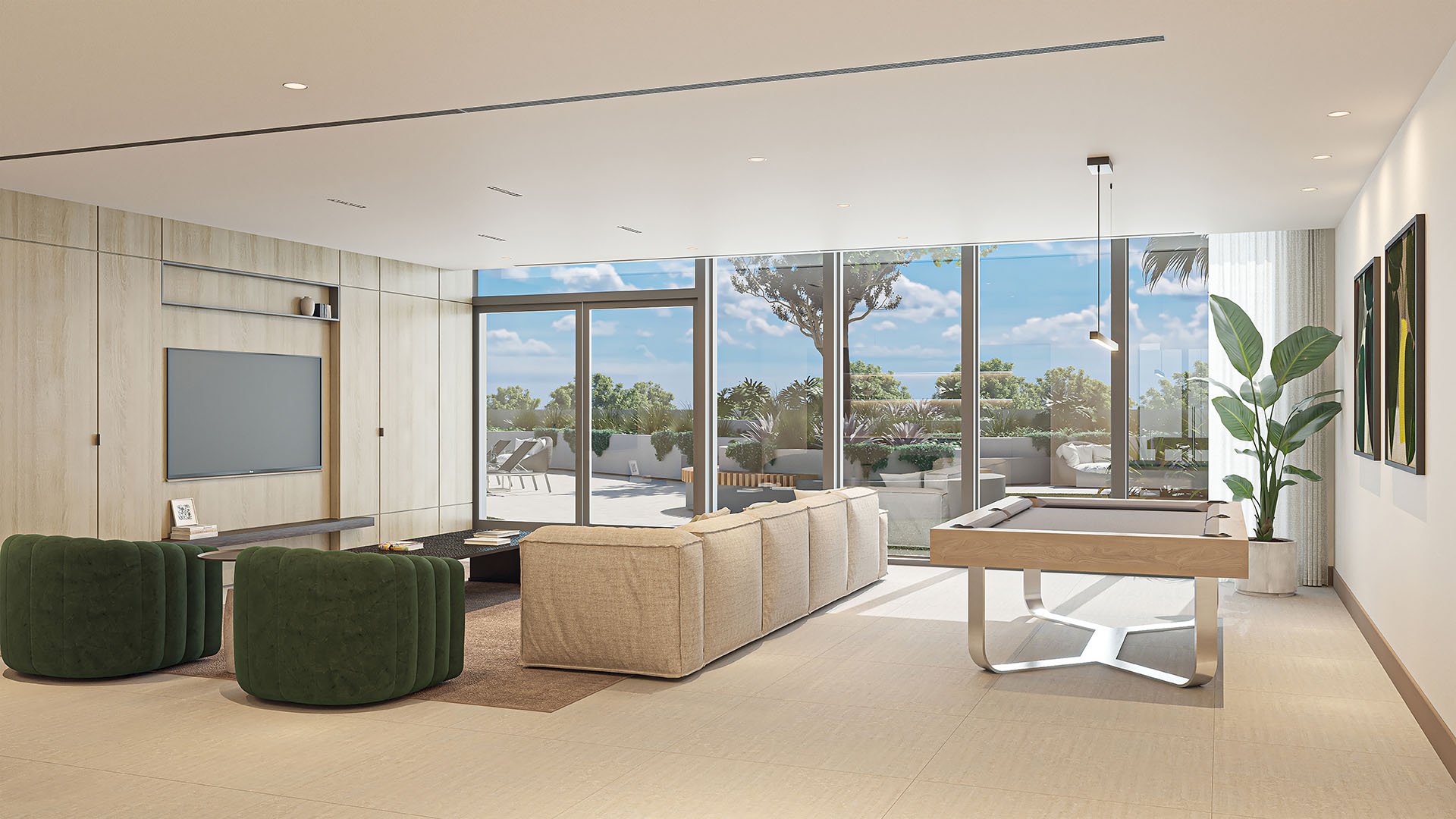 Indoor-outdoor lounge with billiards, sofa seating and sliding glass doors to a terrace at Arbor in Coconut Grove, expressing luxury and ultra luxury condos with relaxed entertainment spaces.