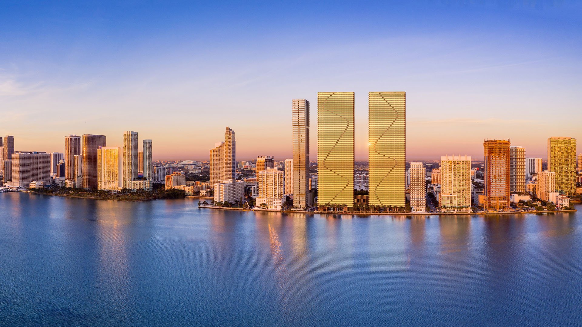 Aria Reserve Edgewater Miami sunset aerial of Biscayne Bay waterfront with twin glass towers and skyline, showcasing luxury and ultra luxury preconstruction condos in Miami's Edgewater district.