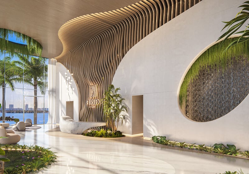 Aria Reserve Edgewater Miami grand lobby with sculptural wood ceiling, curved concierge desk and water feature wall, bay views, showcasing luxury and ultra luxury preconstruction condos arrival experience.