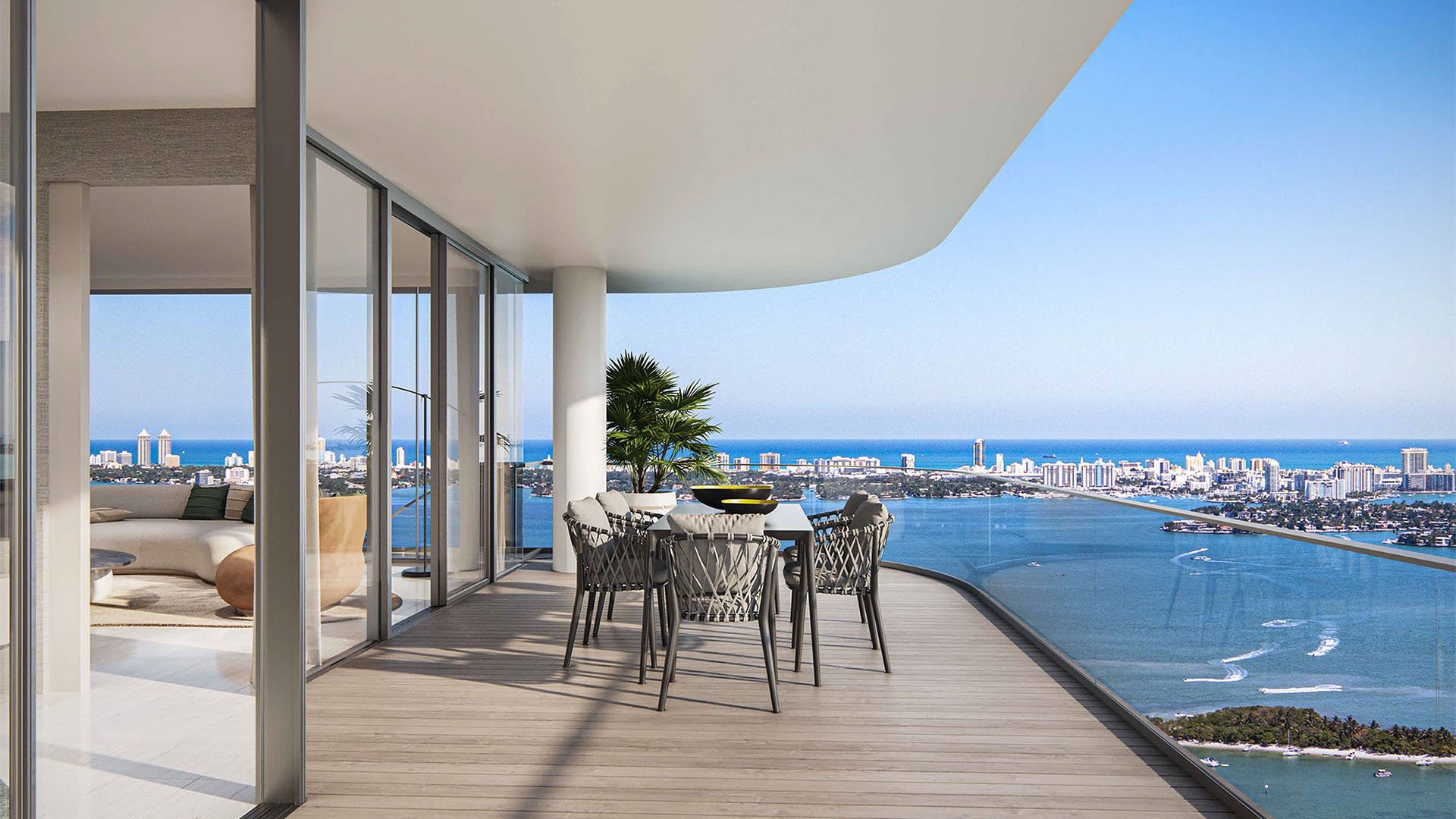 Aria Reserve Edgewater Miami condo balcony dining terrace with panoramic Biscayne Bay and ocean views, showcasing luxury and ultra luxury preconstruction condos indoor-outdoor living.