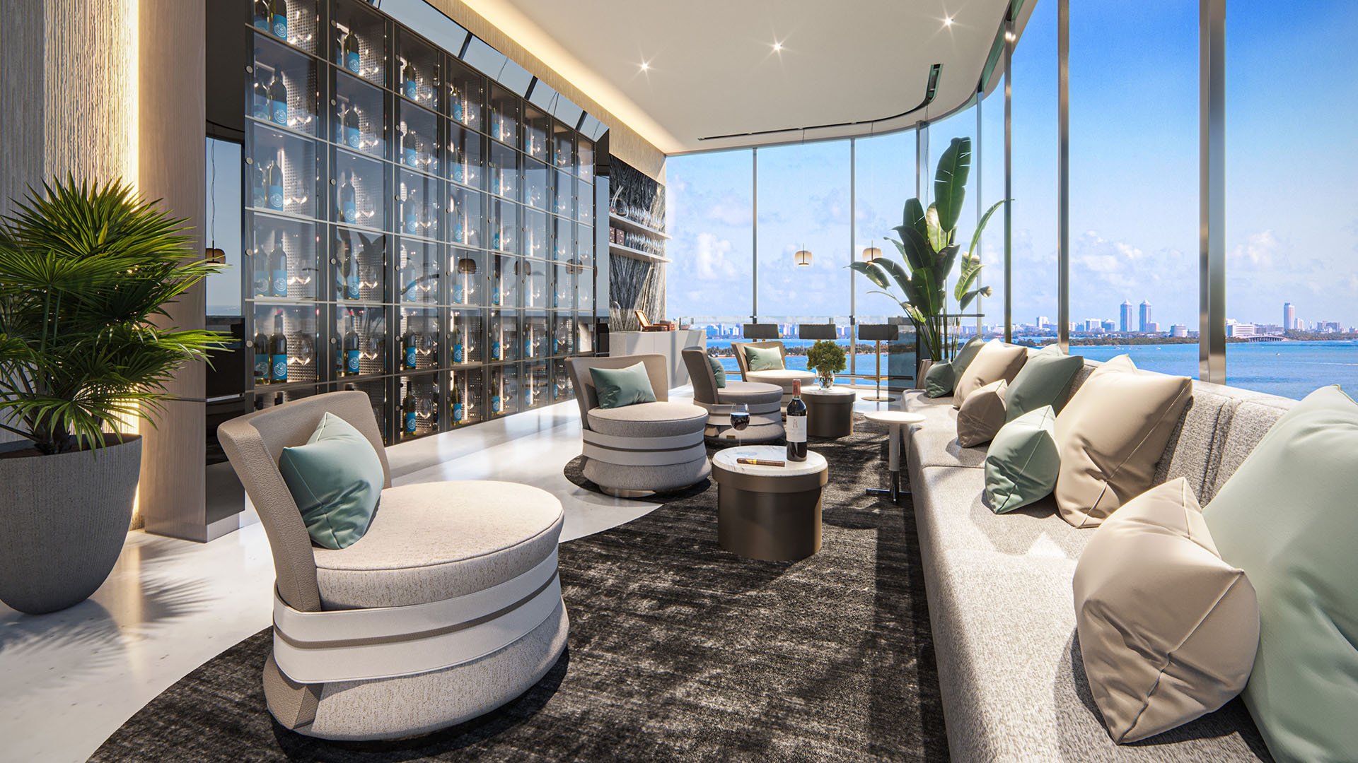 Aria Reserve Edgewater Miami residents lounge with wine display wall, plush seating and floor-to-ceiling windows overlooking Biscayne Bay, showcasing luxury and ultra luxury preconstruction condos amenities.