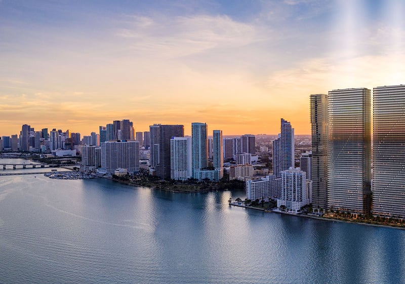 Aerial sunset view of Biscayne Bay and Downtown Miami with Aria Reserve twin towers on the Edgewater waterfront, showcasing luxury and ultra luxury preconstruction condos with panoramic skyline and bay views.