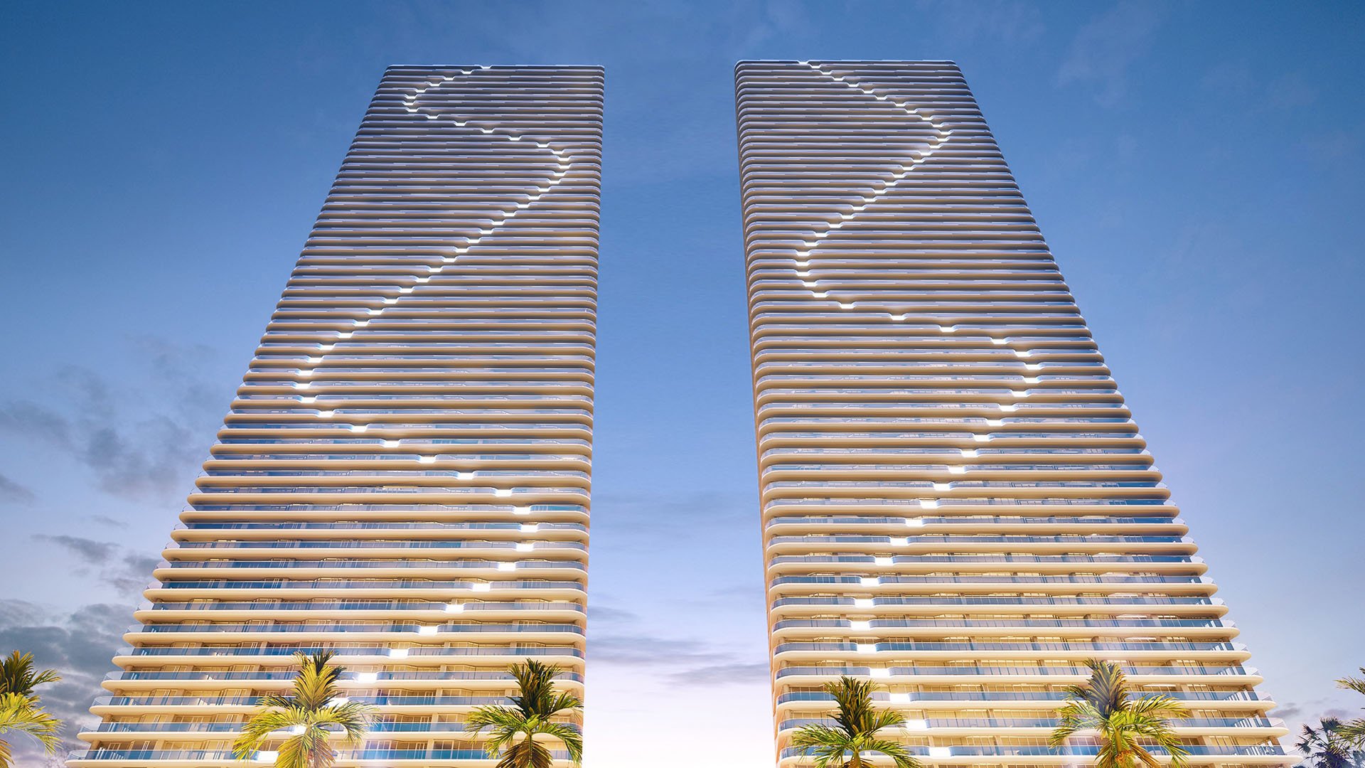Twilight view of Aria Reserve twin towers in Edgewater, Miami, Florida with illuminated balcony lines against the evening sky, showcasing luxury and ultra luxury preconstruction condos on the Biscayne Bay waterfront.