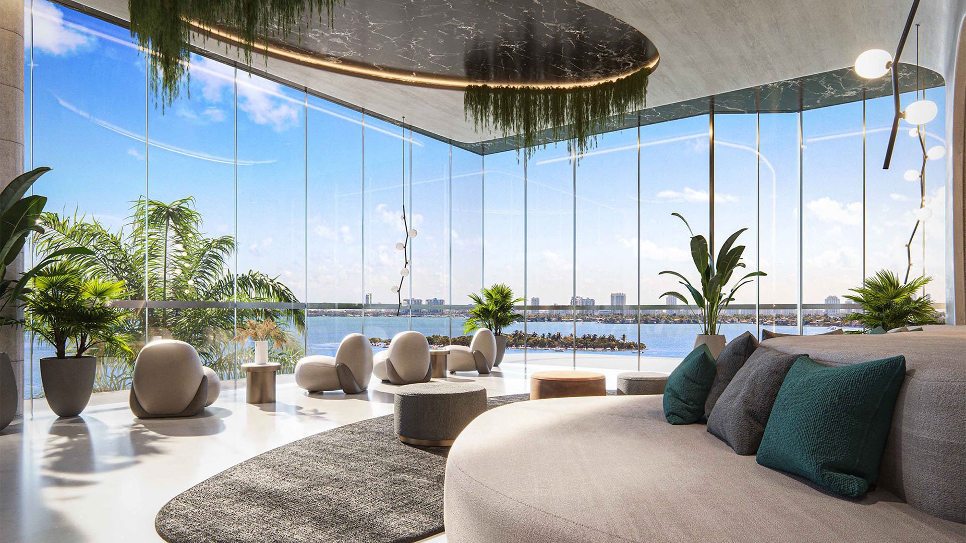 Aria Reserve Edgewater, Miami, Florida bayfront residents lounge with floor-to-ceiling glass, sculptural seating, lush plants and panoramic water views, featuring luxury and ultra luxury preconstruction condos amenity space.