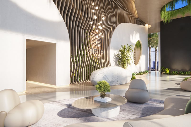 Aria Reserve Edgewater Miami grand lobby with wavy wood feature wall, marble reception desk and lush greenery, setting the arrival experience for luxury and ultra luxury preconstruction condos on Biscayne Bay.