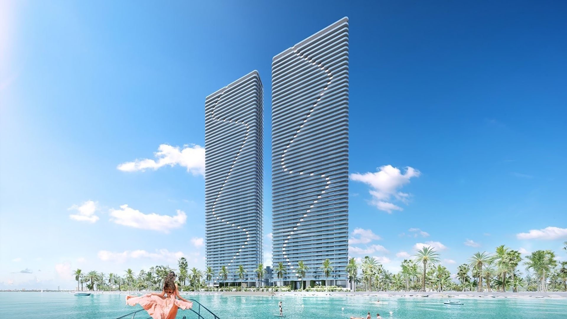 Aria Reserve Edgewater Miami twin towers rising above Biscayne Bay, seen from a boat with turquoise water and shoreline, promoting luxury and ultra luxury preconstruction condos with panoramic bayfront living.