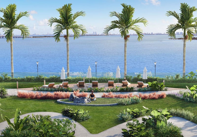 Aria Reserve Edgewater Miami waterfront tropical garden with sun loungers on Biscayne Bay, highlighting luxury and ultra luxury preconstruction condos with landscaped paths, palm trees, and serene bayfront relaxation.
