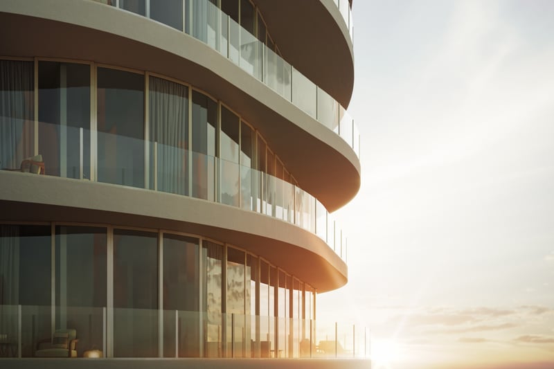 Armani Casa Pompano Beach. Curved, modern glass balconies of a building at sunset, with sunlight reflecting off the windows. Featuring architecture.