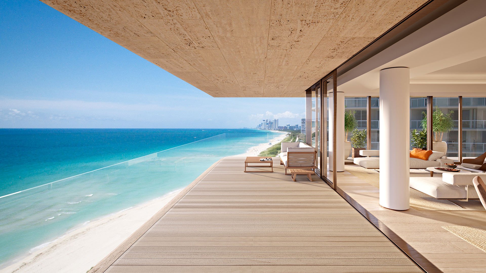 Oceanfront terrace at Arte Surfside, Surfside, Florida, where luxury and ultra luxury condos feature a broad deck, glass walls, and an infinity-edge plunge pool above the beach.