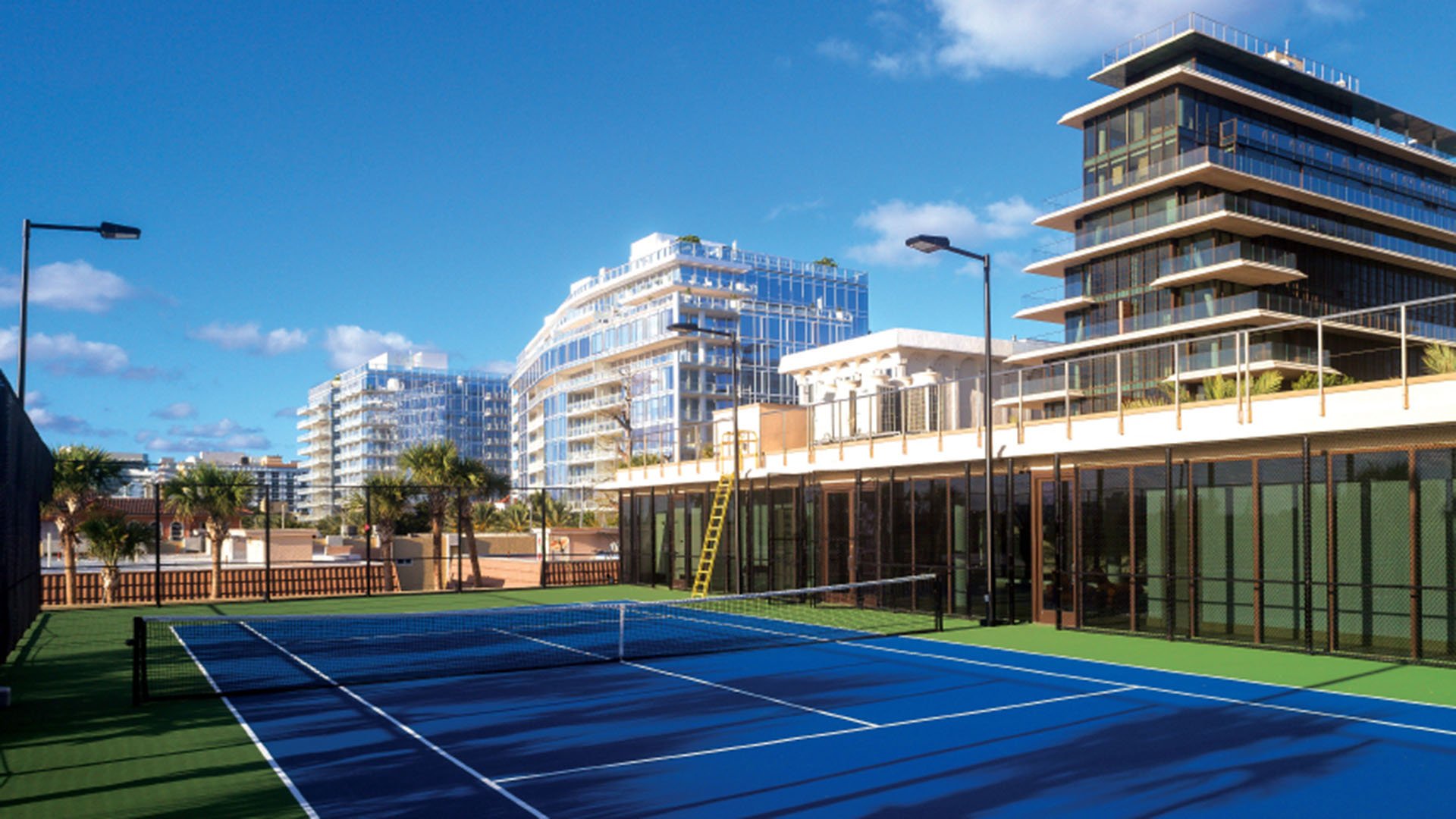 Tennis court at Arte Surfside, Surfside, Florida, where luxury and ultra luxury condos are framed by the stepped facade, glass walls, and surrounding skyline.