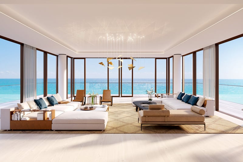 Living room at Arte Surfside, Surfside, Florida, presenting luxury and ultra luxury condos with wraparound glass, expansive sofas, and panoramic ocean views.