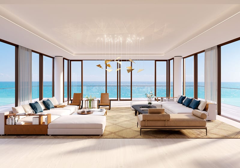 Living room at Arte Surfside, Surfside, Florida, presenting luxury and ultra luxury condos with wraparound glass, expansive sofas, and panoramic ocean views.