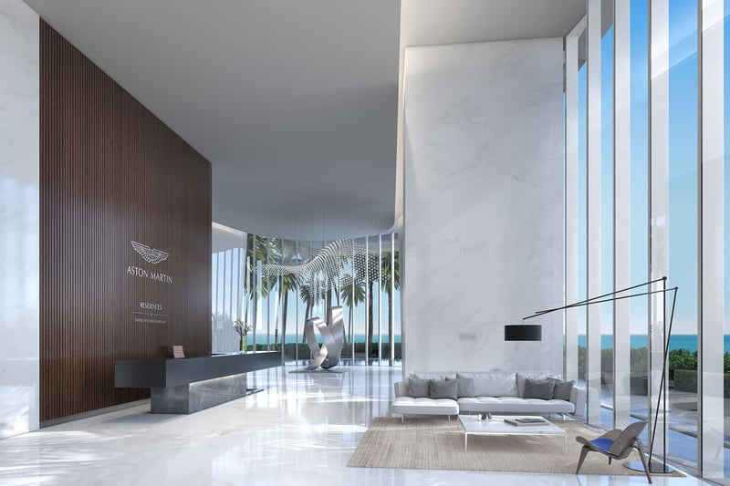 Aston Martin Residences in Downtown Miami luxury and ultra luxury condos arrival lobby with a sculptural art piece, reception desk, marble finishes, and a water view.