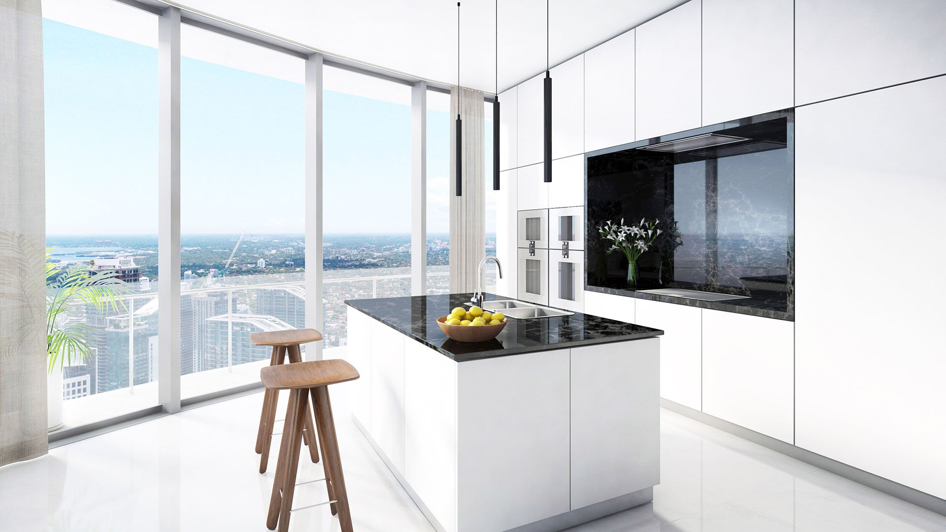 Aston Martin Residences in Downtown Miami luxury and ultra luxury condos bright chef kitchen with a black island, white cabinetry, and high-floor city views through full-height glass.