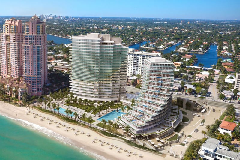 Auberge Beach Residences, Fort Lauderdale luxury and ultra luxury condos aerial waterfront view of curved beachfront towers, pools, the sandy beach, and surrounding coastal waterways.