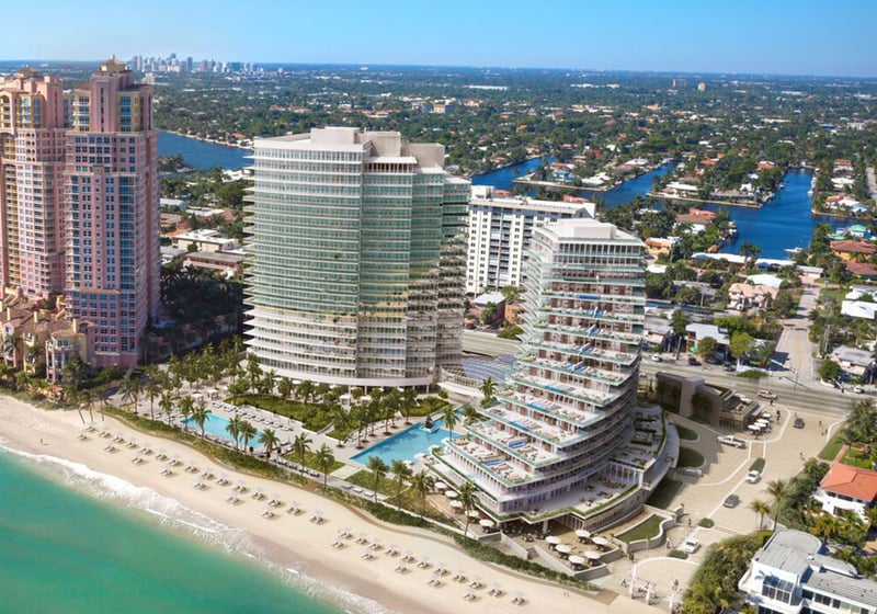 Auberge Beach Residences, Fort Lauderdale luxury and ultra luxury condos aerial waterfront view of curved beachfront towers, pools, the sandy beach, and surrounding coastal waterways.