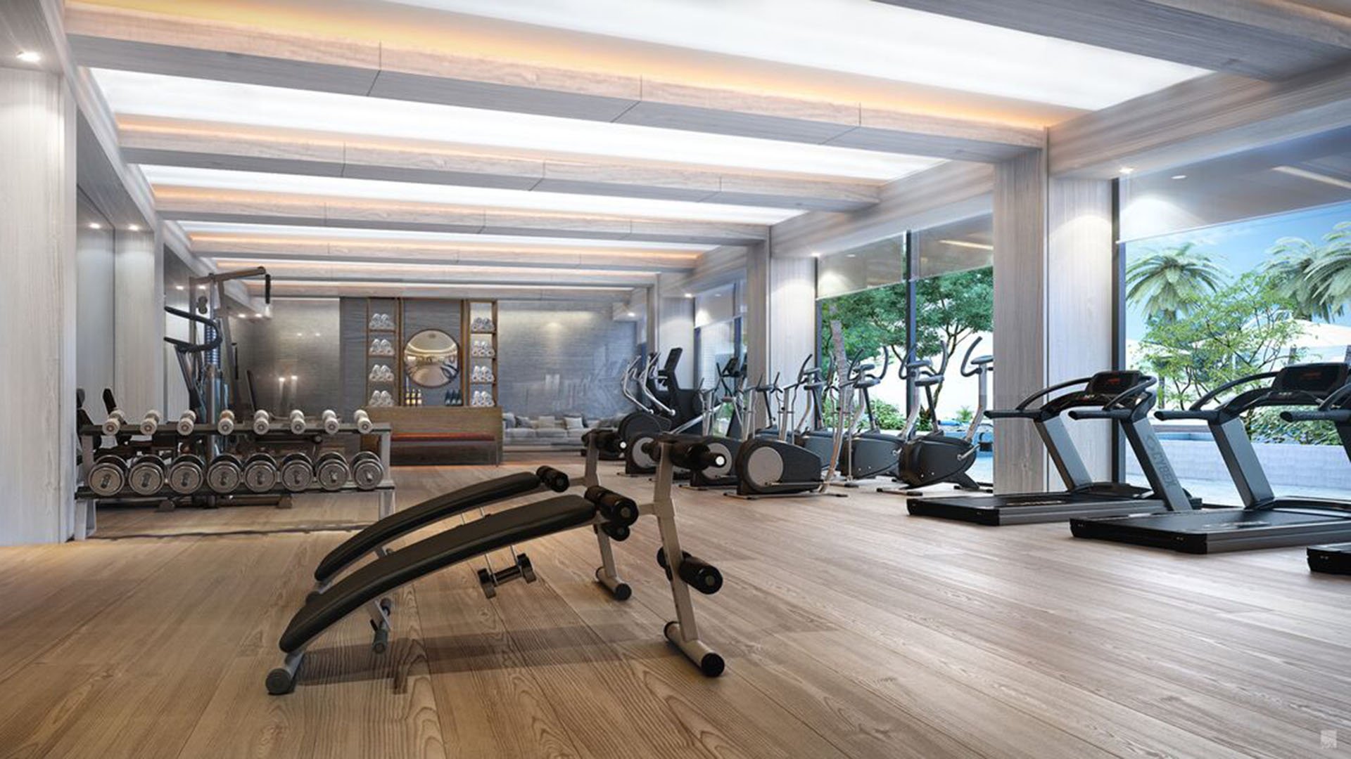 Auberge Beach Residences, Fort Lauderdale luxury and ultra luxury condos fitness center with cardio machines, free weights, wood floors, and oversized windows facing tropical landscaping.