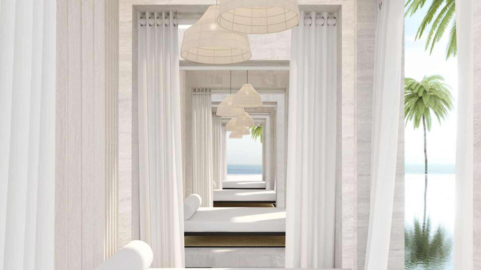 Auberge Beach Residences, Fort Lauderdale luxury and ultra luxury condos spa cabana corridor with white drapery, pendant lighting, massage tables, and a glimpse of the ocean.