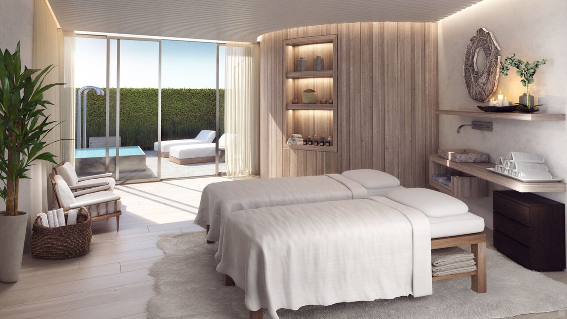 Auberge Beach Residences, Fort Lauderdale luxury and ultra luxury condos spa treatment room with dual massage beds, warm wood detailing, and soft daylight from the outdoor terrace.